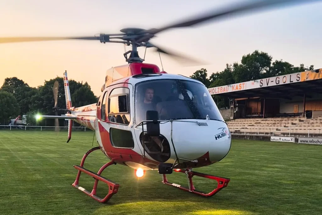 Hubschrauber beim Landen auf einem Fußballplatz